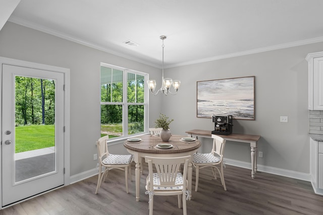 823 Elsie Dr, North Augusta, SC 29860 - dining room featuring healthy amount of natural light, wood finished floors, ornamental molding, and a chandelier