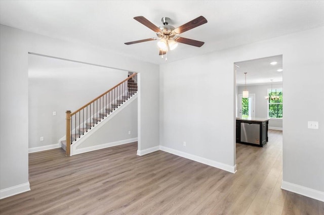 823 Elsie Dr, North Augusta, SC 29860 - empty room with stairs, wood finished floors, a ceiling fan, recessed lighting, and a chandelier