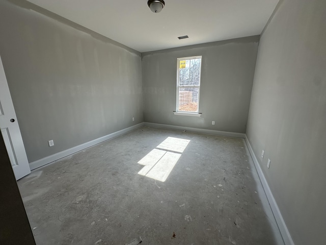 spare room featuring visible vents and baseboards