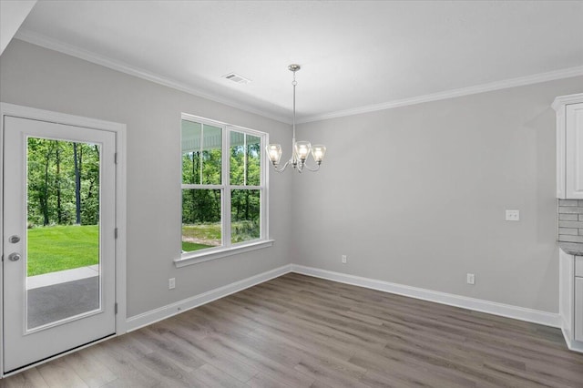 823 Elsie Dr, North Augusta, SC 29860 - unfurnished dining area featuring plenty of natural light, a chandelier, wood finished floors, and ornamental molding