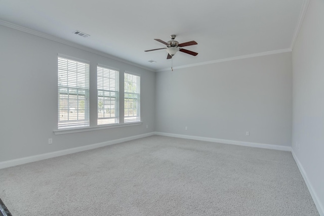 empty room featuring visible vents, baseboards, a ceiling fan, and crown molding