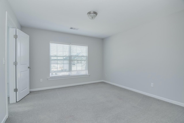 unfurnished room featuring visible vents, carpet floors, and baseboards