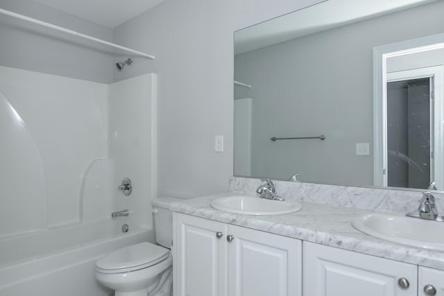 full bath featuring a sink, toilet, and double vanity