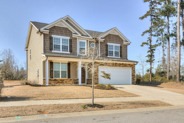 craftsman inspired home featuring driveway, stone siding, a porch, board and batten siding, and an attached garage