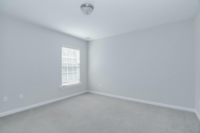 carpeted empty room with baseboards