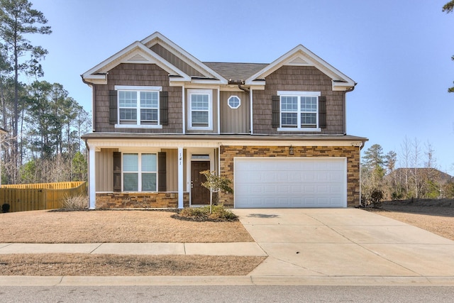 view of front of house with fence, a porch, concrete driveway, a garage, and stone siding