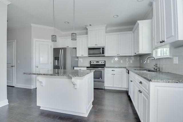 kitchen featuring visible vents, a sink, ornamental molding, stainless steel appliances, and white cabinetry