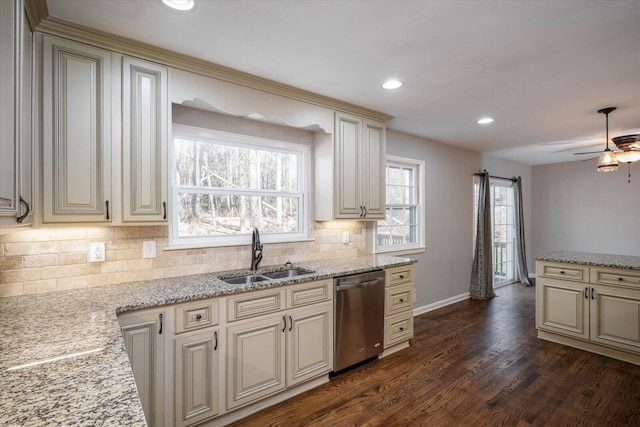 kitchen featuring ceiling fan, dishwasher, sink, dark wood-type flooring, and cream cabinetry