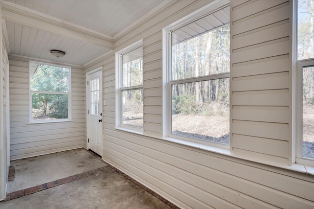 unfurnished sunroom with radiator heating unit and plenty of natural light