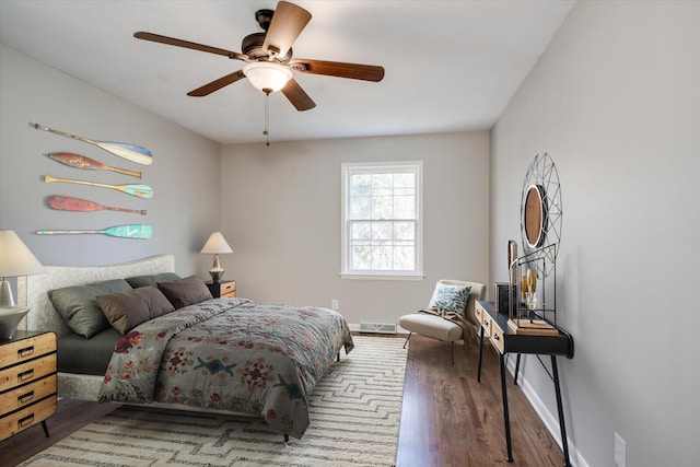 bedroom with ceiling fan and hardwood / wood-style flooring