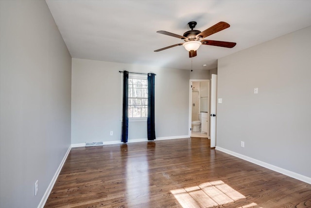 unfurnished room featuring ceiling fan and dark wood-type flooring