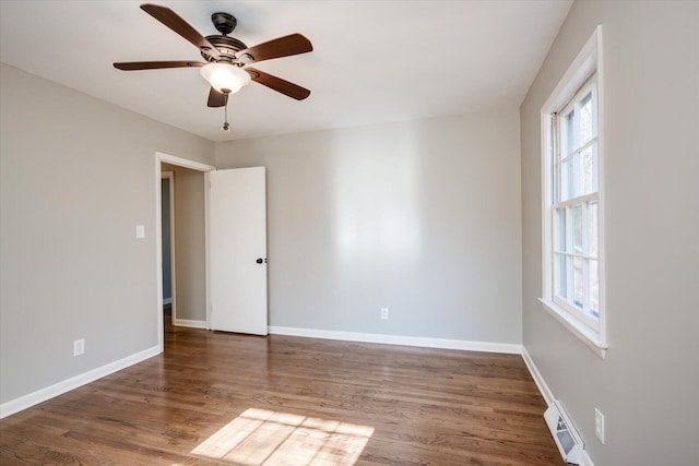 empty room featuring ceiling fan and dark wood-type flooring