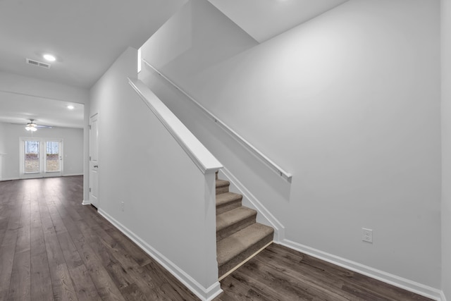 stairway with ceiling fan and hardwood / wood-style flooring