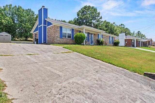 3346 Saddlebrook Dr, Hephzibah, GA 30815 - view of front of property featuring brick siding, a chimney, concrete driveway, and a front yard