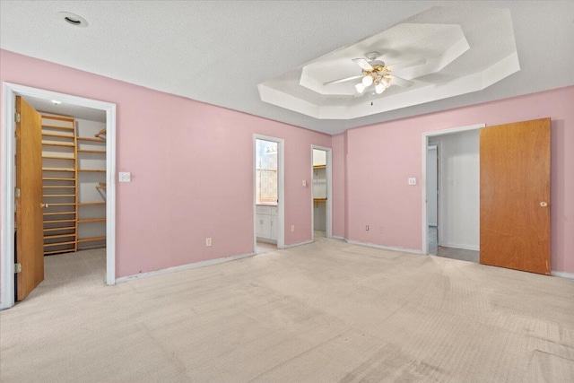 3346 Saddlebrook Dr, Hephzibah, GA 30815 - unfurnished bedroom featuring a spacious closet, a closet, a raised ceiling, and carpet flooring