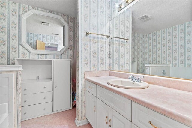 3346 Saddlebrook Dr, Hephzibah, GA 30815 - bathroom featuring wallpapered walls, a textured ceiling, and vanity