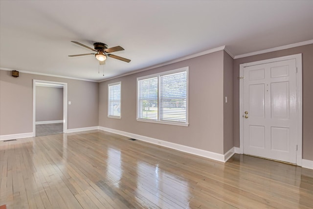 interior space with baseboards, ceiling fan, and crown molding