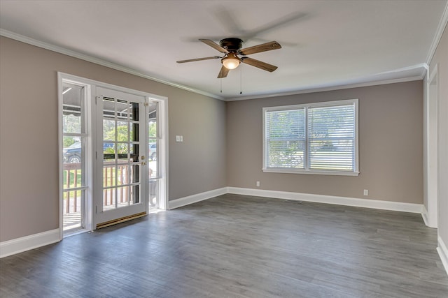 spare room featuring baseboards, dark wood-type flooring, ceiling fan, and crown molding