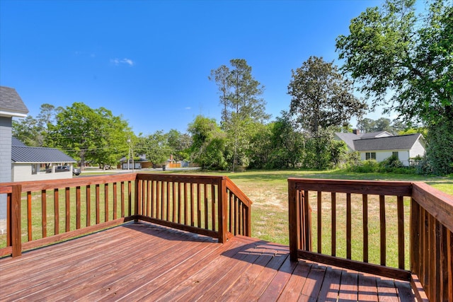 wooden deck with a lawn