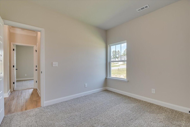 unfurnished room featuring light carpet