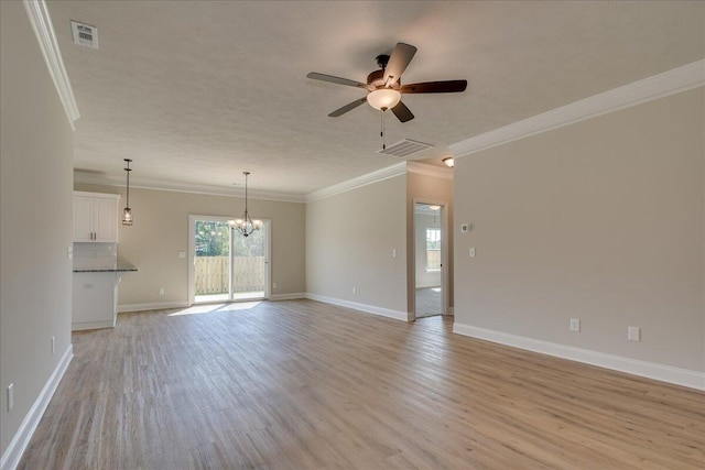 unfurnished living room featuring crown molding, ceiling fan with notable chandelier, and light wood-type flooring