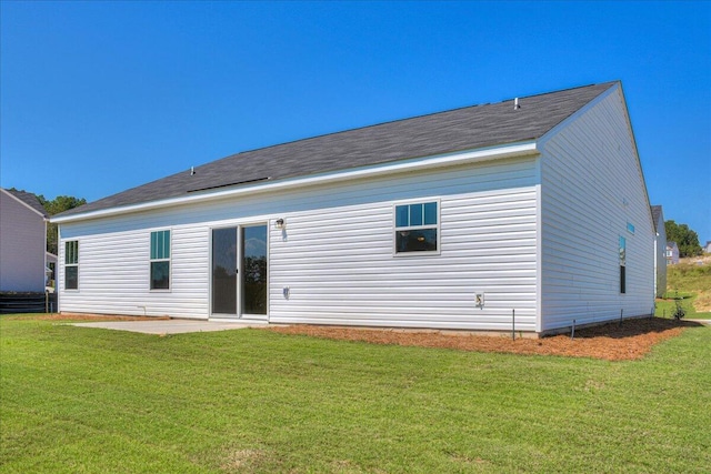 rear view of house featuring a yard and a patio area