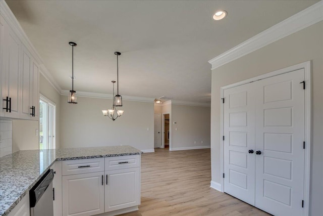 kitchen featuring light stone countertops, stainless steel dishwasher, hanging light fixtures, and white cabinets