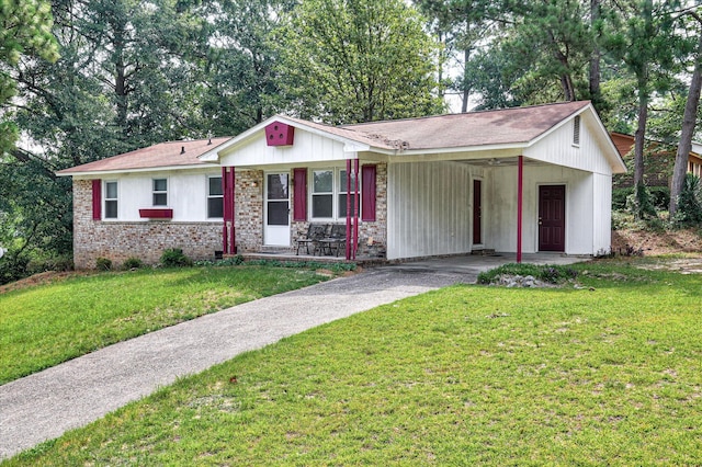 3115 Arcadia Dr, Augusta, GA 30906 - single story home with driveway, an attached carport, a front lawn, covered porch, and brick siding