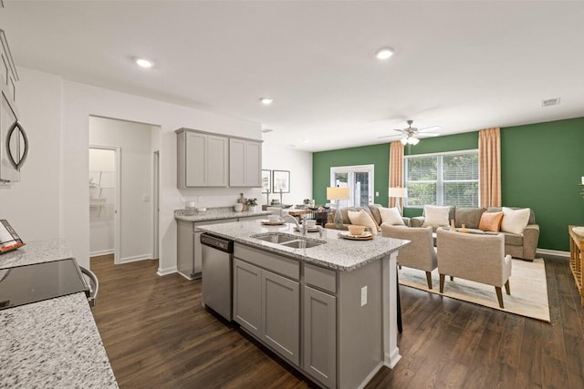 kitchen with a center island with sink, gray cabinets, sink, and appliances with stainless steel finishes