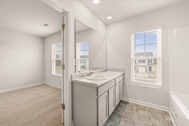 bathroom with vanity and a bathtub