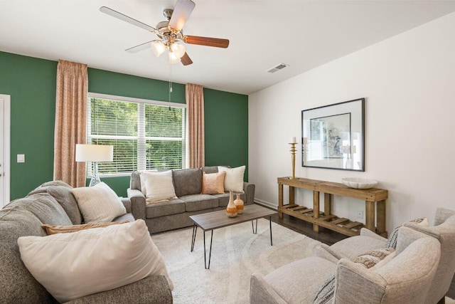 living room featuring ceiling fan and dark hardwood / wood-style flooring