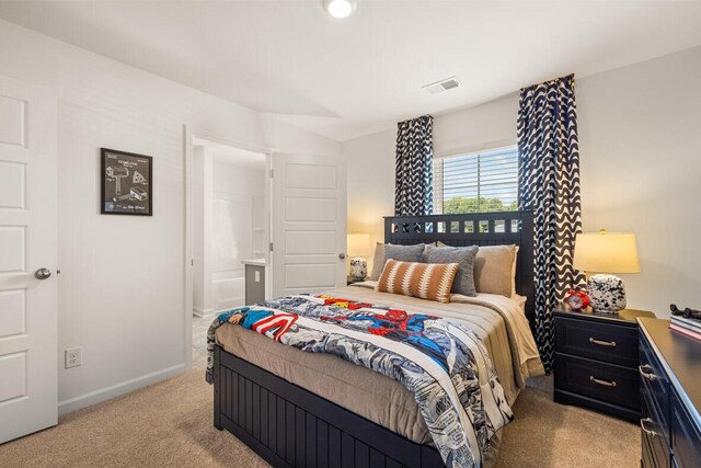 bedroom featuring light colored carpet