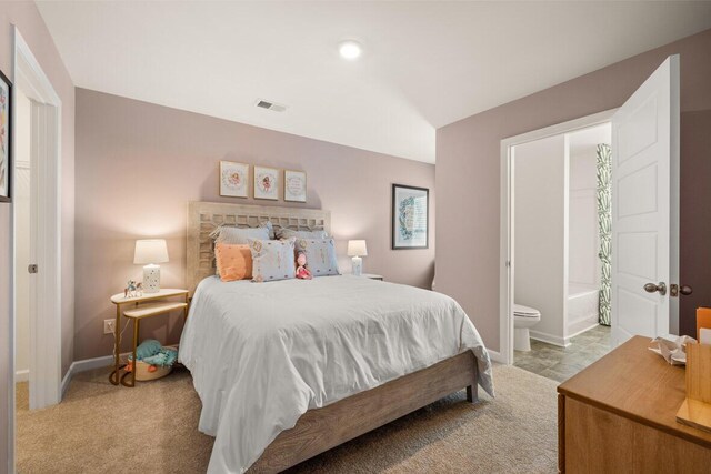 carpeted bedroom featuring connected bathroom