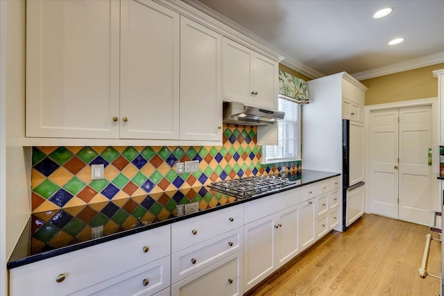 kitchen with white cabinetry, backsplash, crown molding, and stainless steel gas cooktop