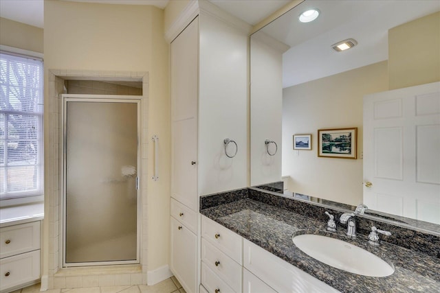 bathroom featuring vanity, a healthy amount of sunlight, an enclosed shower, and tile patterned floors