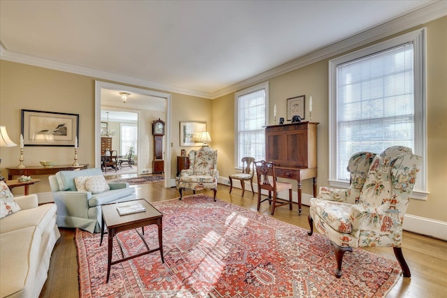 living room featuring crown molding and light hardwood / wood-style floors