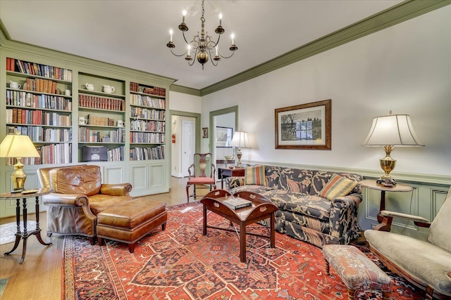 living room featuring ornamental molding, light wood-type flooring, and an inviting chandelier