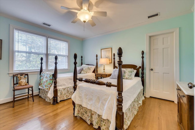 bedroom featuring crown molding, ceiling fan, and light wood-type flooring