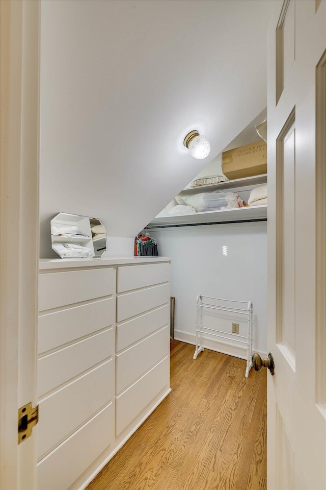 interior space featuring vaulted ceiling and light hardwood / wood-style floors