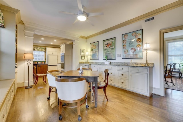 dining room with ornamental molding, plenty of natural light, ceiling fan, and light hardwood / wood-style floors