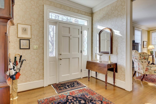 foyer featuring ornamental molding and light wood-type flooring