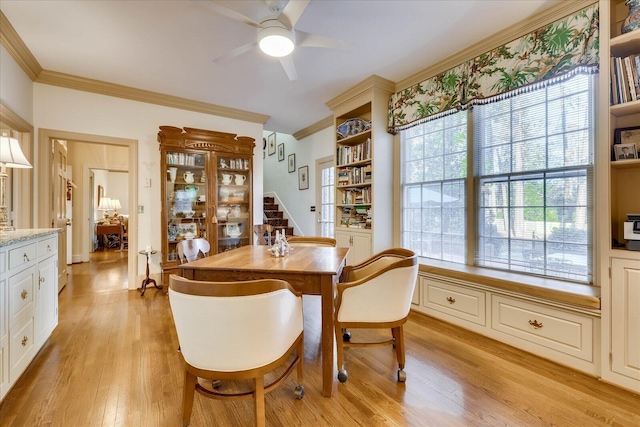 dining area featuring ceiling fan, ornamental molding, and light hardwood / wood-style floors