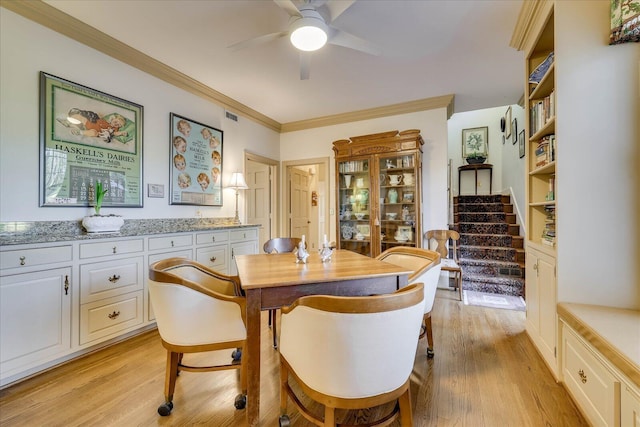 dining room featuring crown molding, ceiling fan, and light hardwood / wood-style flooring