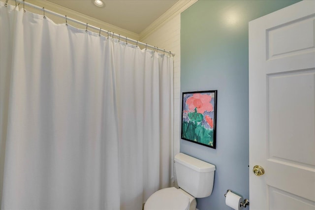 bathroom featuring crown molding and toilet