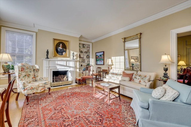 living room with crown molding, a wealth of natural light, built in features, and wood-type flooring