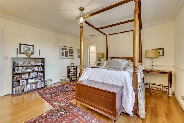 bedroom with light hardwood / wood-style flooring and ornamental molding