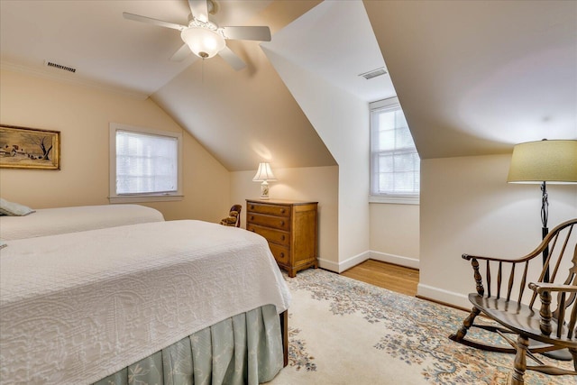 bedroom with lofted ceiling, ceiling fan, and light hardwood / wood-style flooring