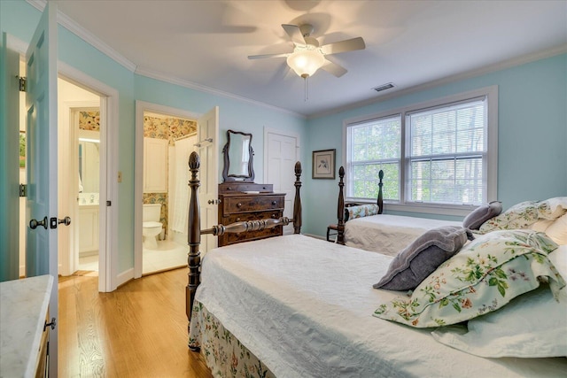 bedroom featuring crown molding, ensuite bath, light hardwood / wood-style floors, and ceiling fan