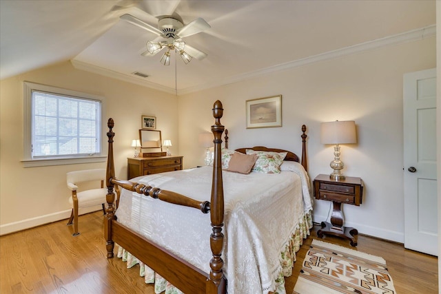 bedroom featuring lofted ceiling, ornamental molding, and light hardwood / wood-style flooring