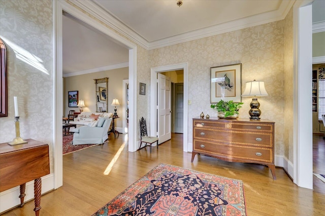 entrance foyer with crown molding and light hardwood / wood-style flooring